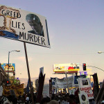 Greed_Lies_Murder_Protest_sign