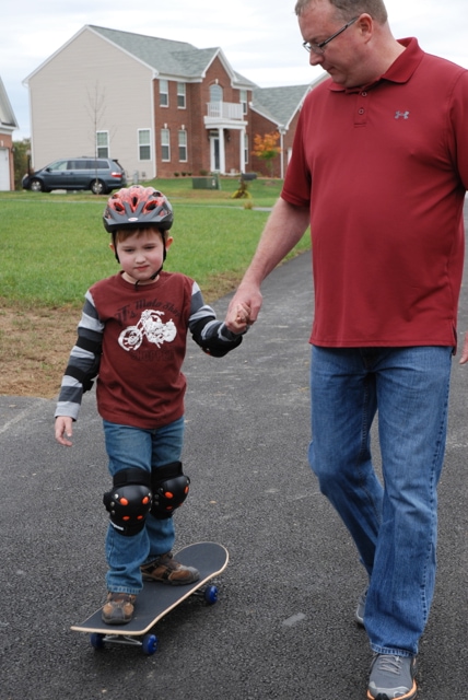 dad and son skateboarding
