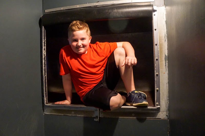 Crawling through a duct at the International Spy Museum