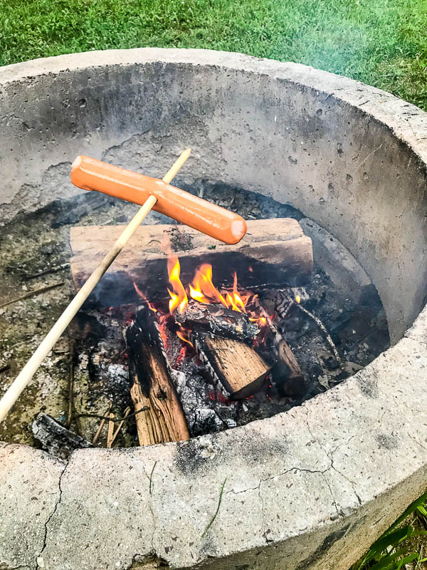 Cooking hot dogs over the fire