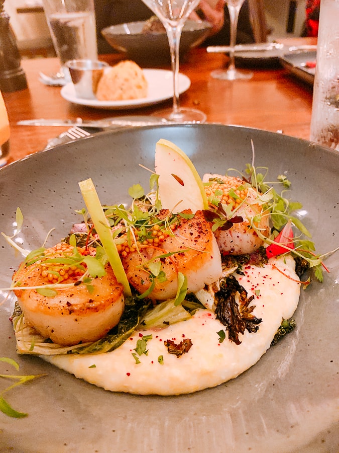 scallops served on smoked cheddar grits