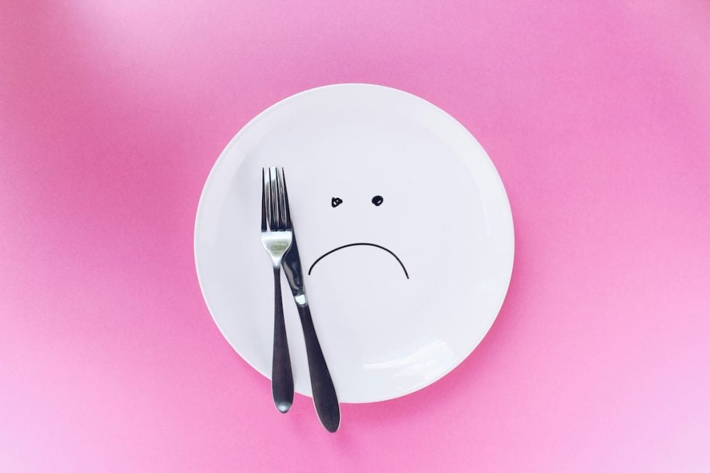 Sad plate on a pink background