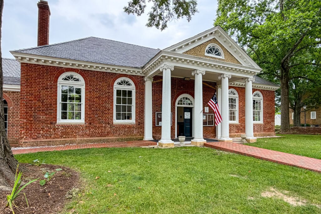 Elegant brick building with white columns and American flag in Gloucester, Virginia.